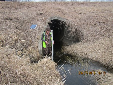 Image slide of Installing the level logger at a stream monitoring site.
