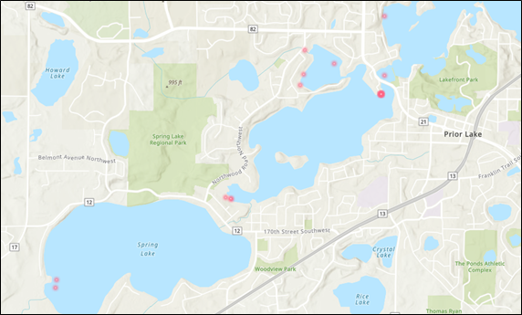 A map of three lakes with red dots clumped around the shorelines. There are 11 dots visible. The first lake is in the lower left hand corner, the second in the middle, and the third in the upper left hand corner and extending past the edge of the image. The lakes are generally oblong in shape, with more width tan height.